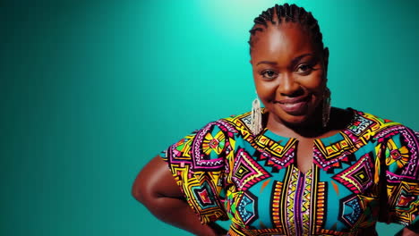 portrait of a smiling woman in a colorful african print dress