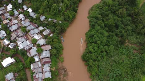 Motorboat-travelling-along-the-murky-Pai-River-at-Huay-Pu-Keng-Kayan-Village,-Thailand