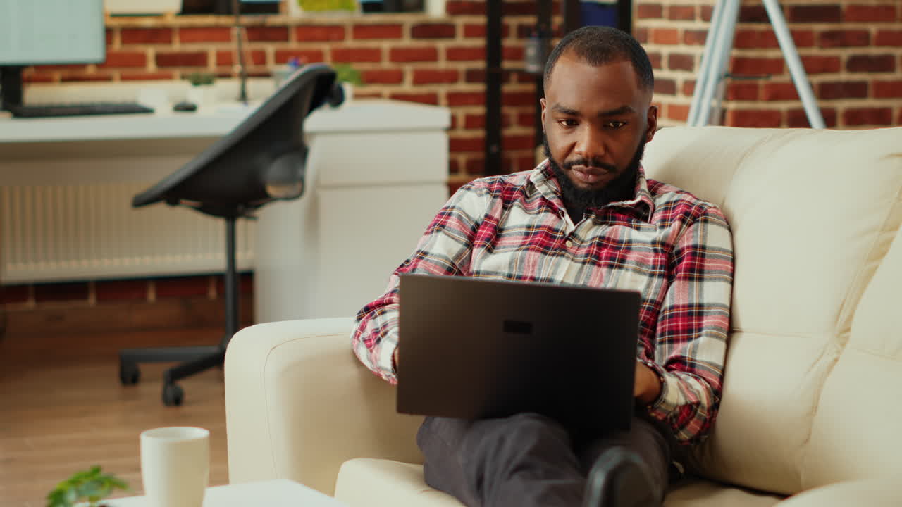 Man working on laptop at home