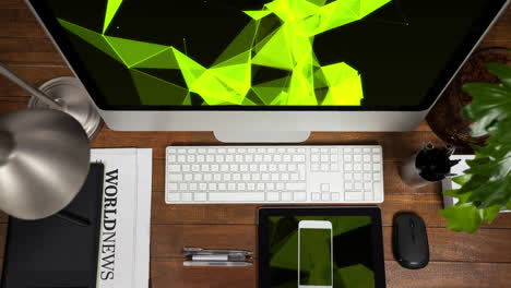 Animation of technological devices with green shapes on screen on wooden desk
