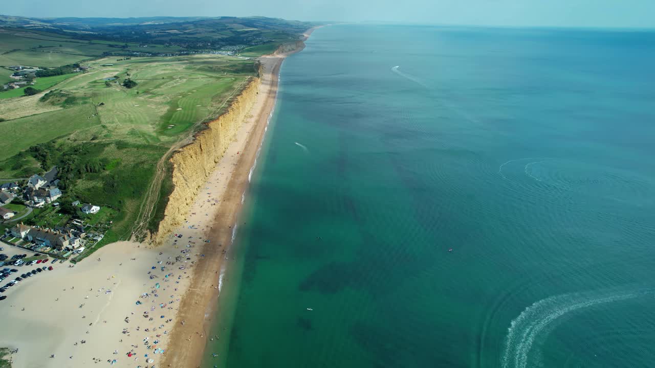 Bridport West bay cliffs above British seaside turquoise ocean coastline aerial view, Dorset