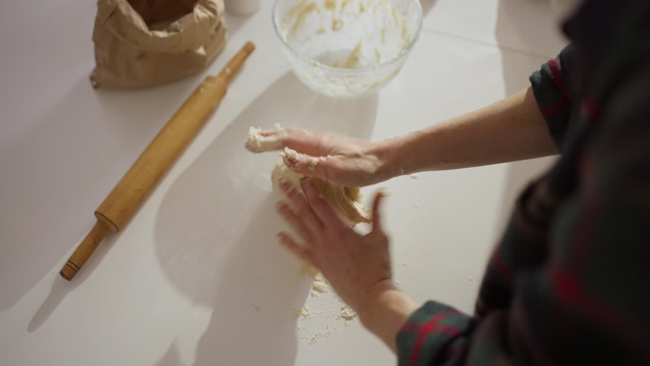 Woman kneading dough on a table