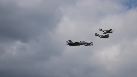 the f-35 military fighter aircraft flies through the air in a beautiful formation next to each other at the air show called airpower with other three aerobatic pilots