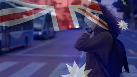 australian flag waving against woman wearing face mask