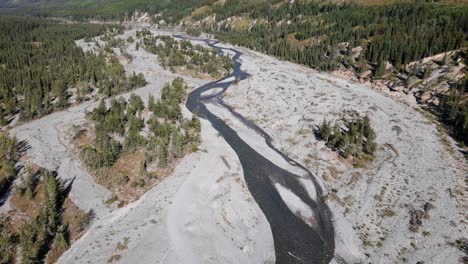 Aerial-footage-of-a-long,-flat-valley-with-the-ghost-river-flowing-through-it