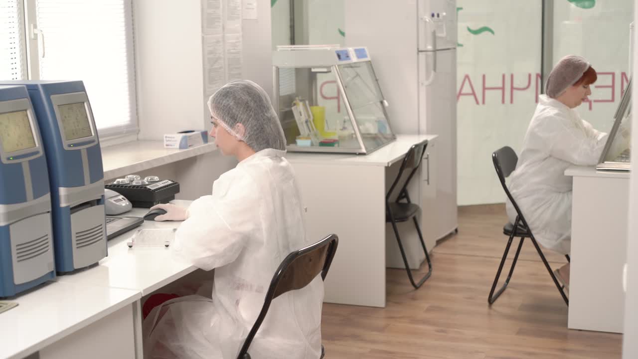 Researchers working in a lab. Scientist working in laminar air flow cabinet. Professional laboratory medical equipment. Healthcare concept.