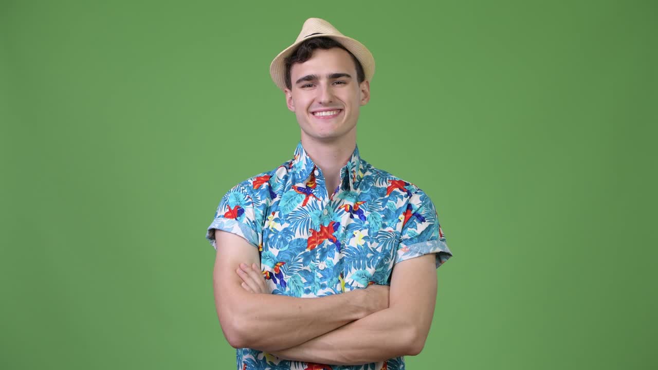 Young handsome tourist man with arms crossed