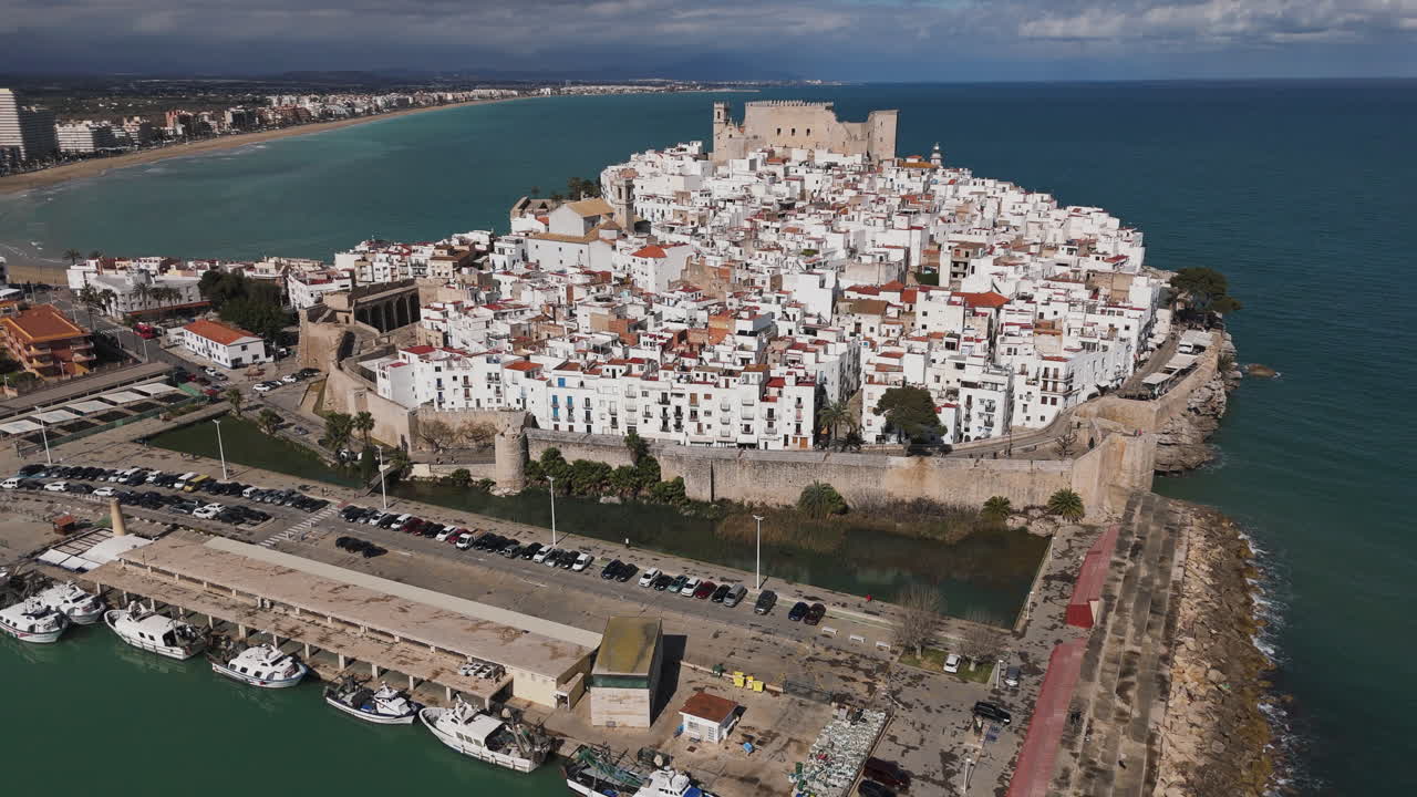 View across rooftops of Peniscola with Castell de Peniscola standing above historic center