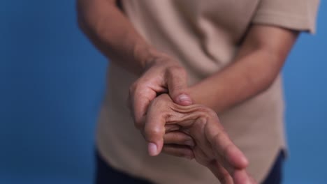 man massaging his painful wrist