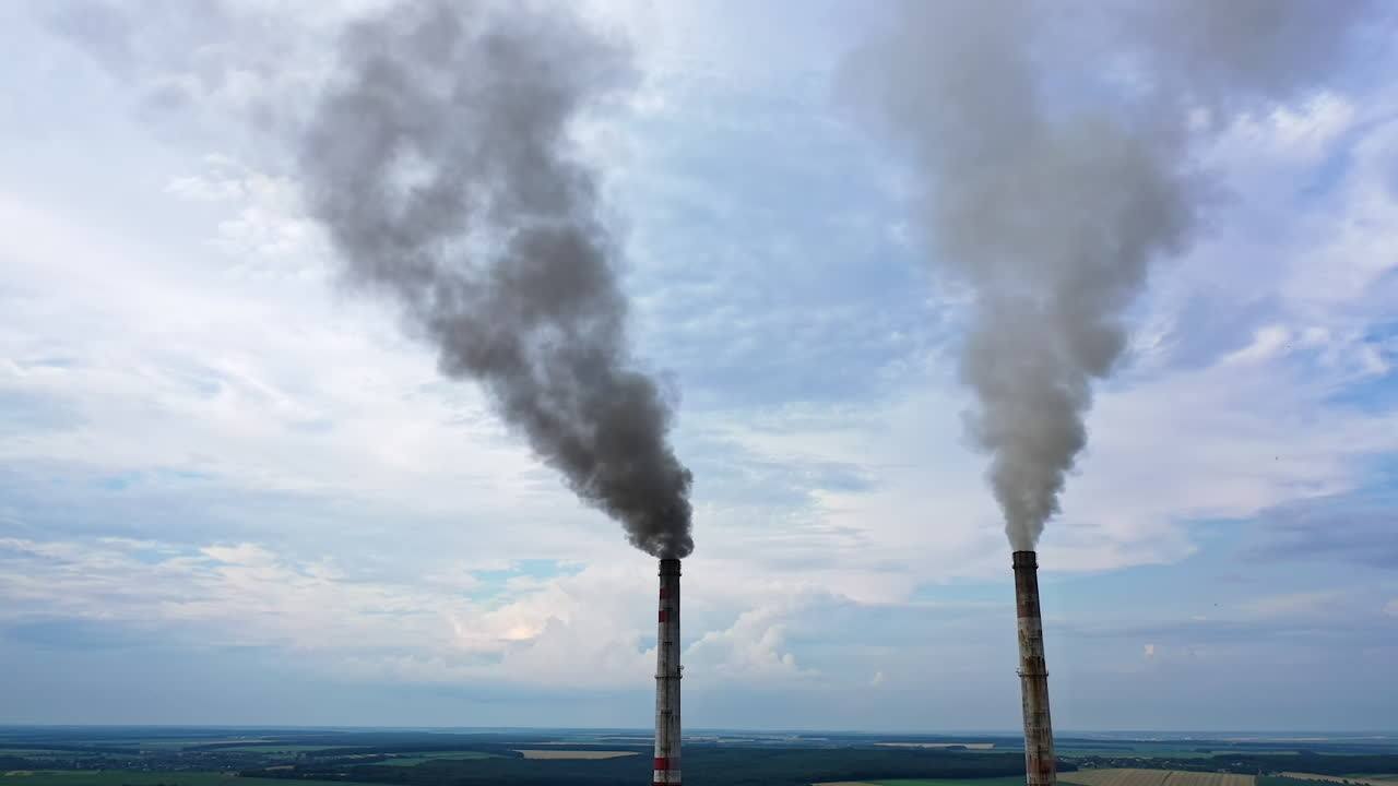 Pipes Throwing Smoke In The Sky. Industrial zone with large smoke from the factory pipes