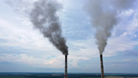 pipes throwing smoke in the sky. industrial zone with large smoke from the factory pipes