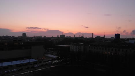 aerial takes of munich by night showing the sunset - twilight from a drone view