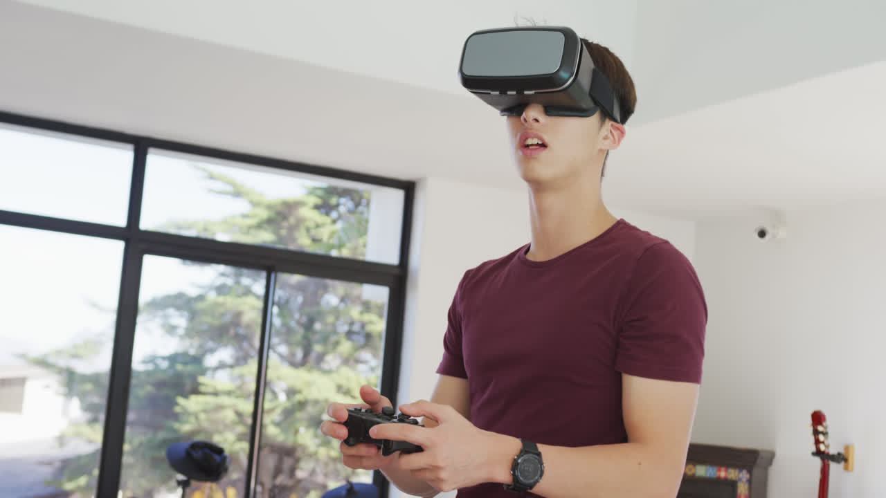 Asian boy wearing vr headset playing video games at home