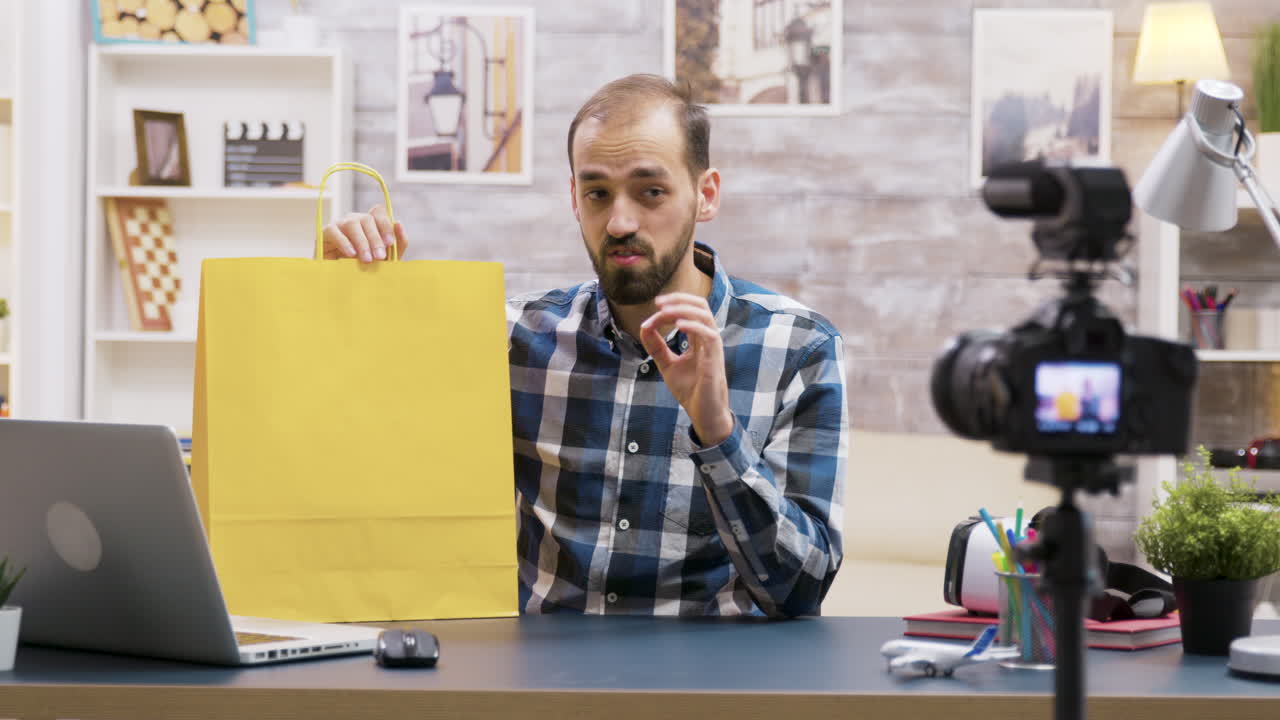 Man recording a vlog with a shopping bag