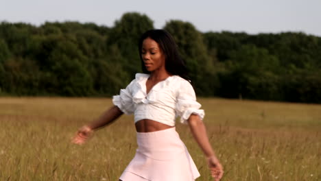 Black-woman-doing-different-poses-for-camera-in-yellow-field-during-a-warm-sunny-day-during-sunset