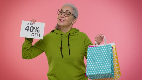abuela mayor mostrando bolsas de compras y hasta un 40 por ciento de descuento en inscripciones pancarta, viernes negro