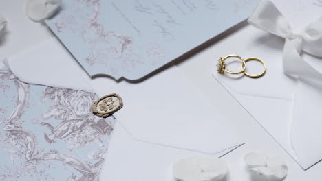 elegant wedding invitation suite with gold rings and wax seal