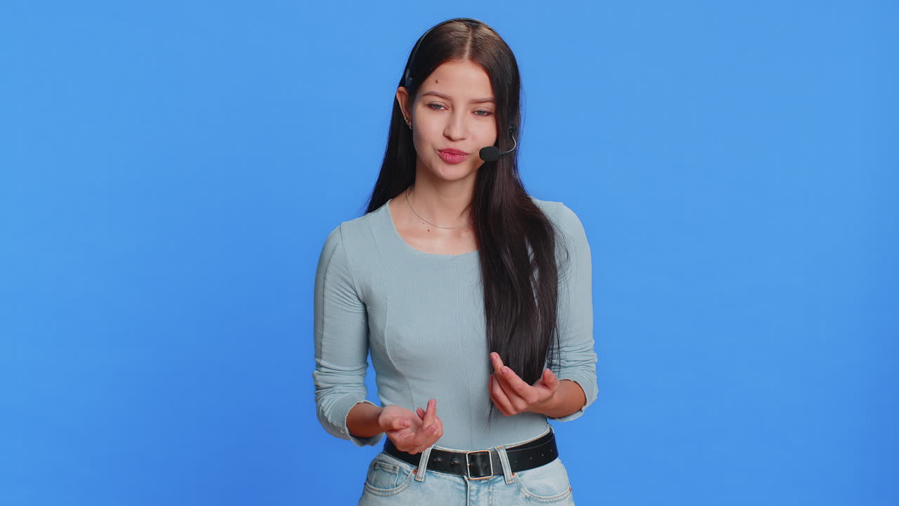 Young woman freelance worker in headset call center support service operator helpline having talk