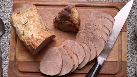 slices of pork loin meat cooked in the oven on a wooden board