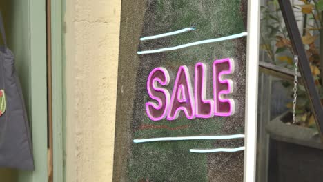 neon sale sign in a store window