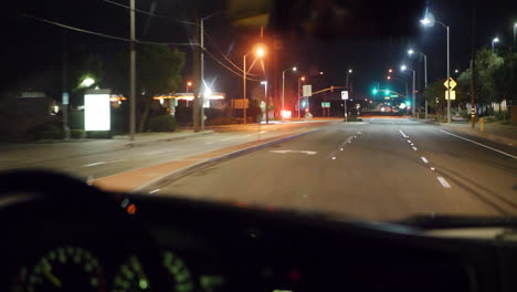 looking out of the car windshield of a commuter driving to los angeles for work very early in the morning to miss traffic