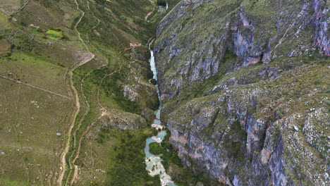 beautiful slow motion drone shot of a beautiful lake between mountains with turquoise waters called millpu in ayacucho, peru