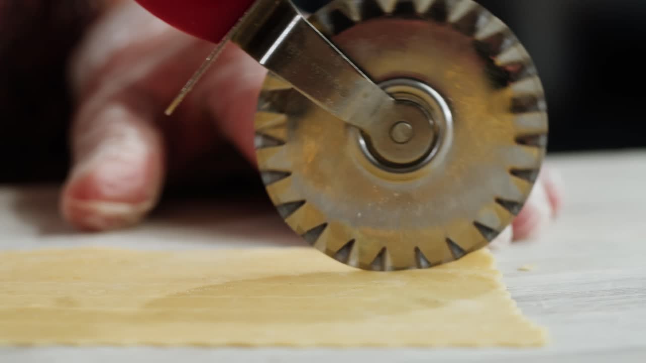 Close-up of Pasta Cutter Slicing Fresh Dough