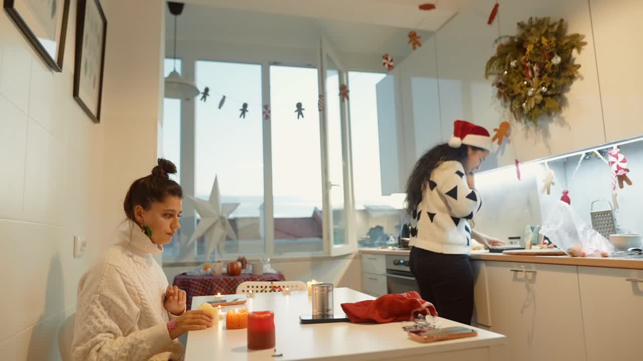 Two women in a kitchen decorating for Christmas