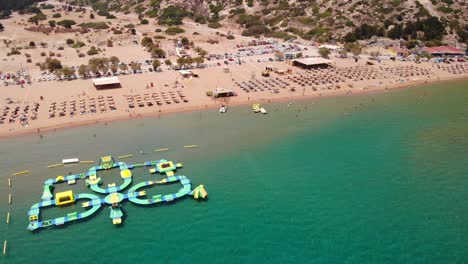 inflatable island at water park in tsambika beach, greece