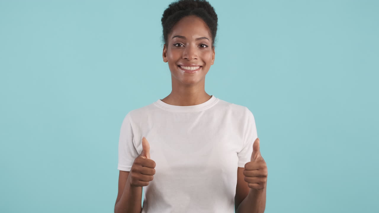 Smiling woman giving thumbs up
