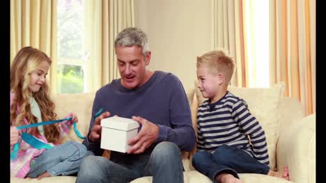 children giving their father a gift