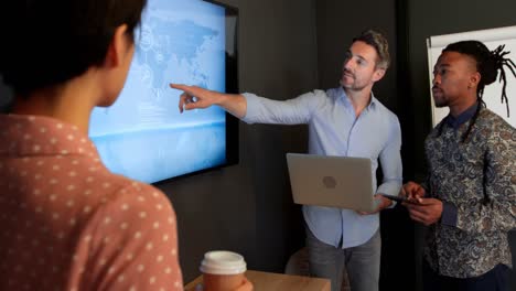 business colleague discussing over digital screen 4k