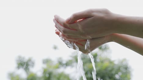 splash of clean water flows into the hands. the concept of saving water to make it last for a long time. conservation of natural resources.