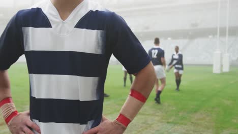 rugby player with hands on hip standing in the stadium 4k