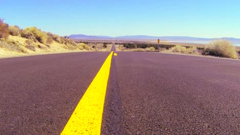 Dolly-shot-along-an-open-road-past-the-center-line-