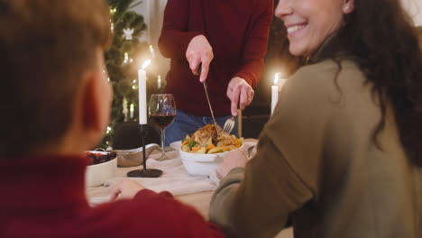 family sitting at christmas dinner table 1