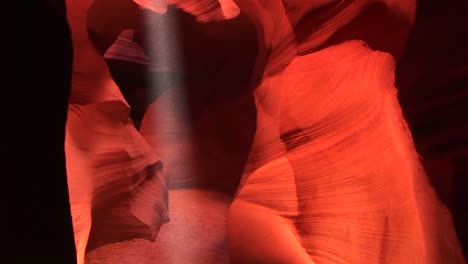 panup of a shaft of light illuminating the interior of a crevasse in antelope canyon arizona