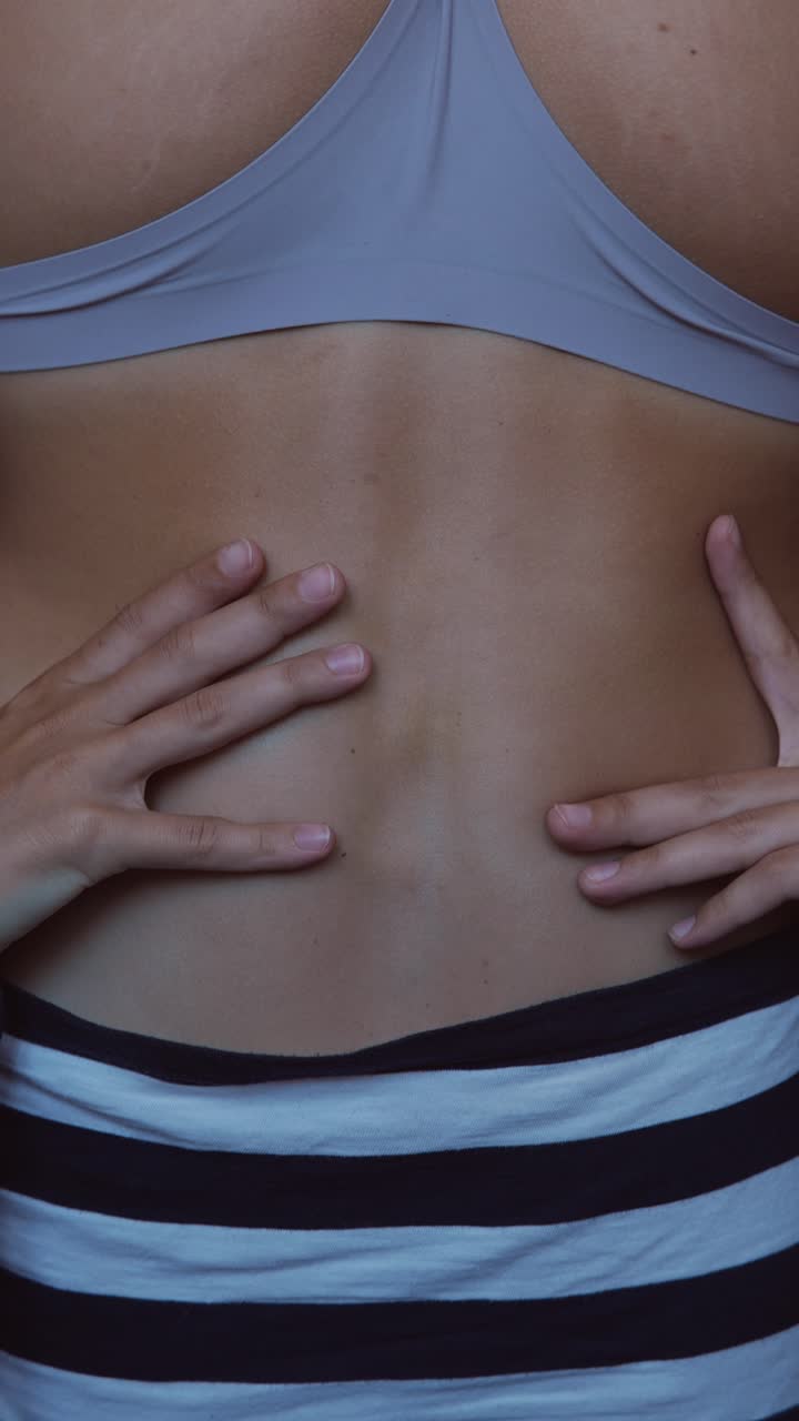 女性の背中を手で