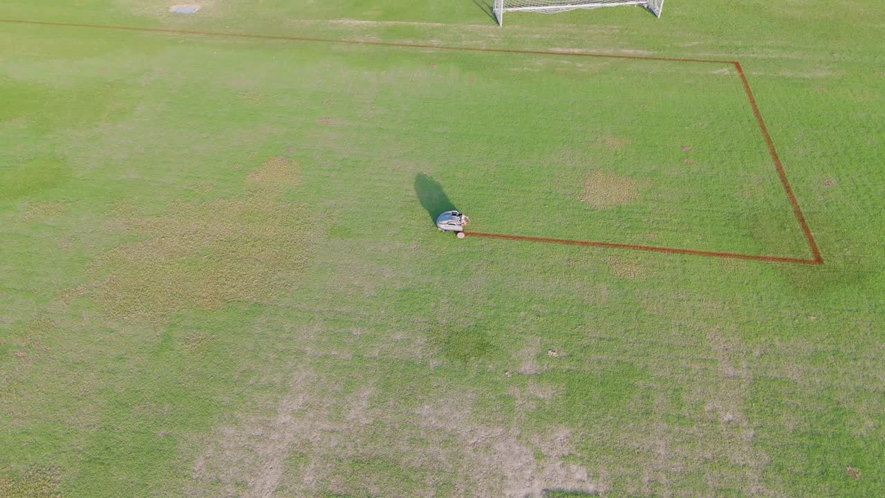 A robot autonomously paints precise lines on a soccer field, showcasing advanced field marking technology