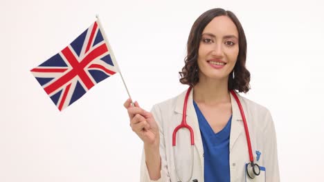 smiling female doctor holds uk flag