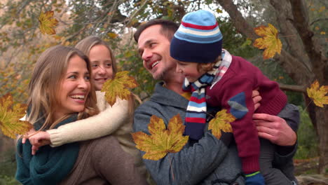 animación de hojas de otoño que caen sobre una feliz familia caucásica en el parque