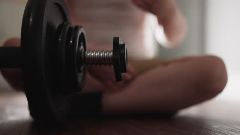 playful little boy removes gear from heavy barbell with hand