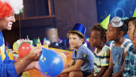 animation of confetti falling over diverse children and clown at birthday party