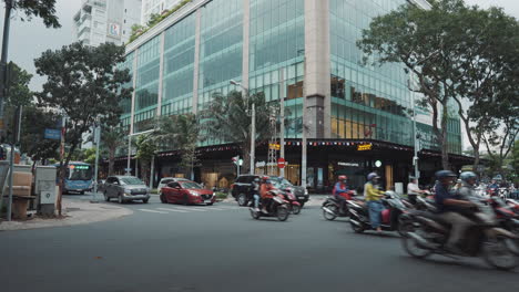 busy city street with motorbikes and buildings