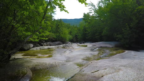 HD-stationary-shot-Maine-forest-wilderness-Stepp-Falls-Hiking-trail-area-filled-with-cascades-and-waterfalls-with-large-crystal-clear-pools-of-water-for-swimming