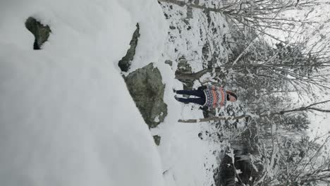 Vertical-Shot-Of-Snow-Covered-Mountain-Trails-Of-Mount-Chauve-With-Female-Hiker-In-Orford,-Quebec-Canada