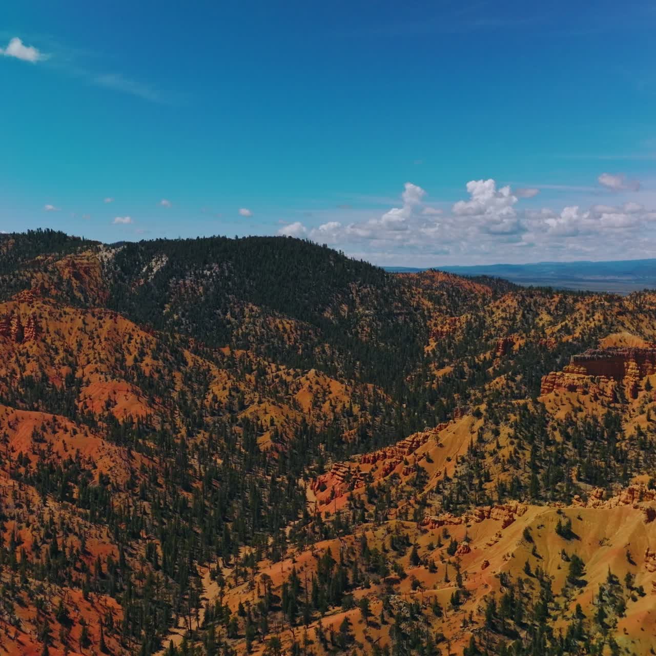 Lovely blue skies with little clouds over the magnificent mountains. Sunny day footage over National Park in Utah, USA