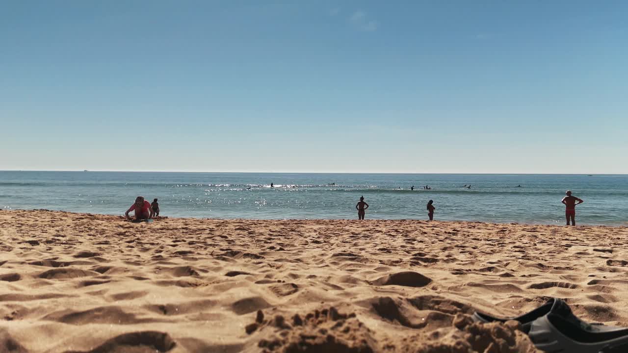 Beach scene with people and surf