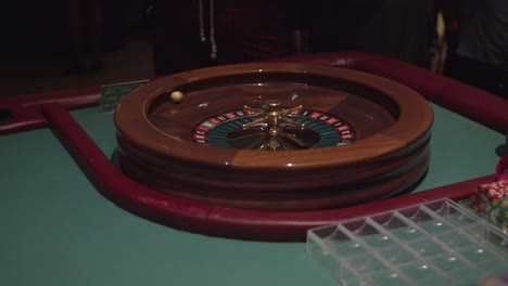 black female woman spinning roulette wheel and spinning ball