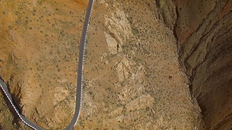Aerial view of the winding mountain road between two villages of Fuerteventura.